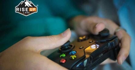 girl with console playing a game