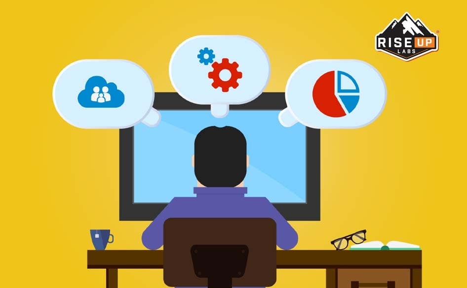 person working in a computer in front of a yellow wall