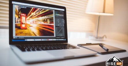 laptop on a desk with a photo editing software
